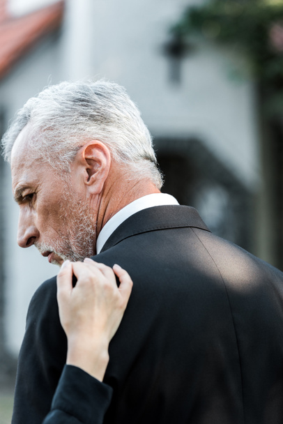 cropped view of woman touching senior man with grey hair on funeral  - Fotoğraf, Görsel