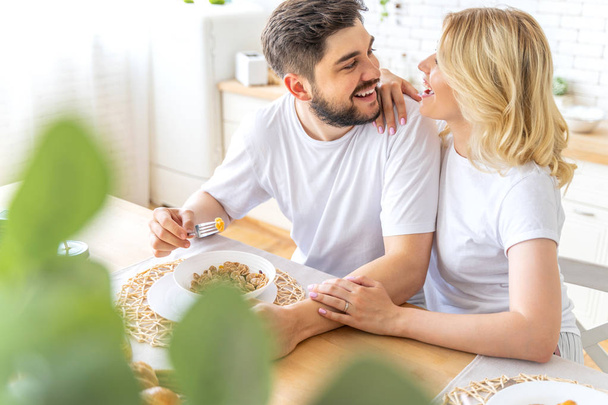 Loving couple is having breakfast together at home - Photo, image