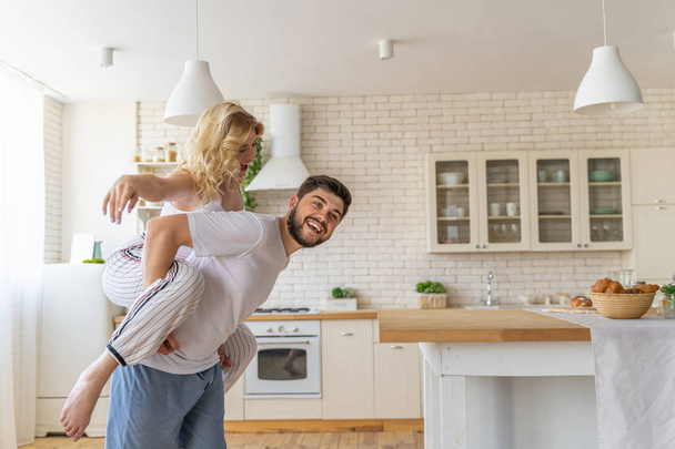 Happy man and woman having fun in the apartment - Foto, imagen