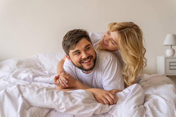Happy lady is lying in bed with boyfriend - Zdjęcie, obraz