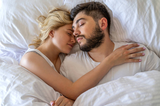 Pretty woman is sleeping near her boyfriend - Valokuva, kuva