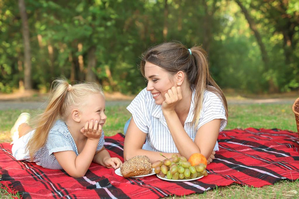 Happy mother and daughter at picnic outdoors - Foto, Imagen