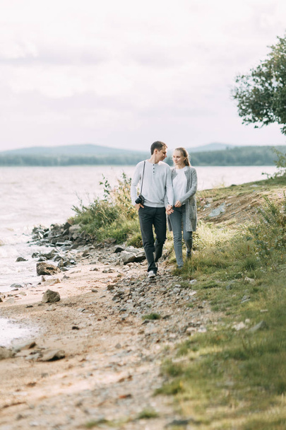 travel walk in the woods. young couple walking on the lake.  - Foto, Bild
