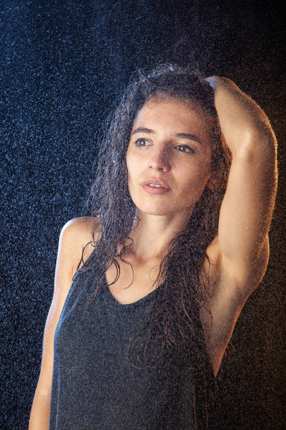 Closeup portrait of sexy wet brunette in black shirt - Foto, imagen