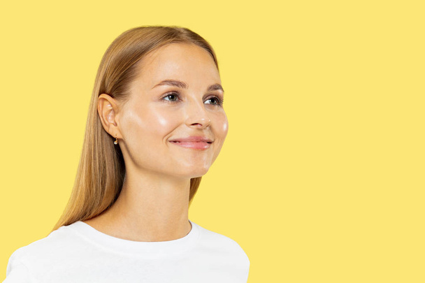 Caucasian young womans half-length portrait on yellow background - Foto, immagini