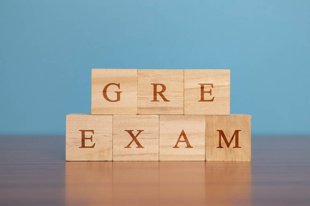 Concept of GRE Exam in wooden block letters on table. - Foto, imagen