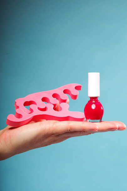 foot pedicure red nail polish and toe separators - Foto, Imagen