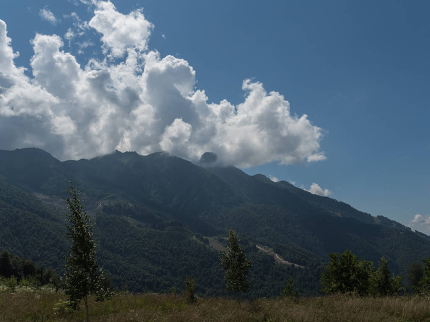 Beautiful green mountains and clouds in the resort of Rosa Khutor - Photo, Image