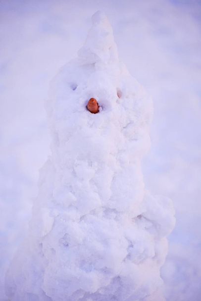 cute snowy snowman in the evening at the christmas city with nobody - Photo, Image