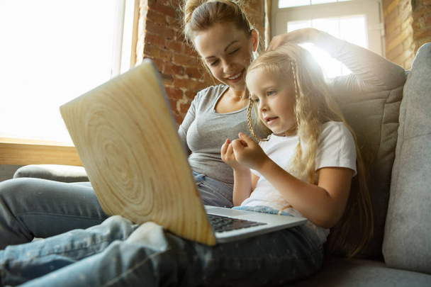 Teacher and little girl, or mom and daughter. Homeschooling concept - Фото, зображення