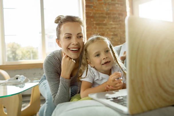 Teacher and little girl, or mom and daughter. Homeschooling concept - Foto, imagen