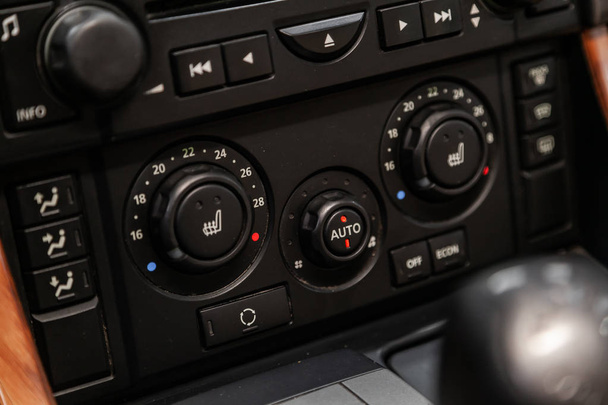Novosibirsk, Russia  August 19, 2019: Land Rover Range Rover Sport, Modern black car interior: climat control view with air conditioning button  - Фото, зображення