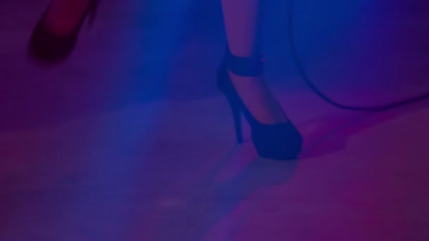 ZALEC, SLOVENIA  - 1. DECEMBER 2017 A performer is wearing high black heels on stage. The whole room is dark. - Felvétel, videó