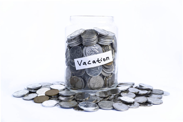 Saving idr coins in the glass bottle jar for vacation - Photo, Image