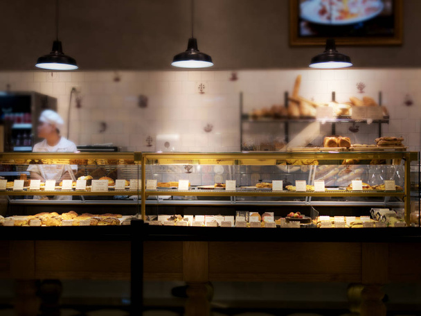 Partially blurred of bakery shop with bakery showcase and variet - Photo, Image