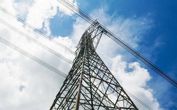 Electricity pylons with blue sky and white clouds. High voltage  - Foto, imagen