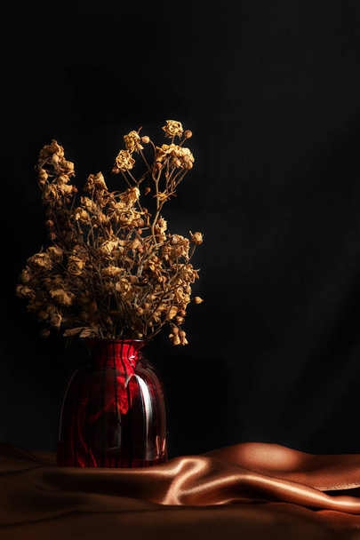 Still life image of dry bouquet of white rosr in vase setting on - Fotó, kép