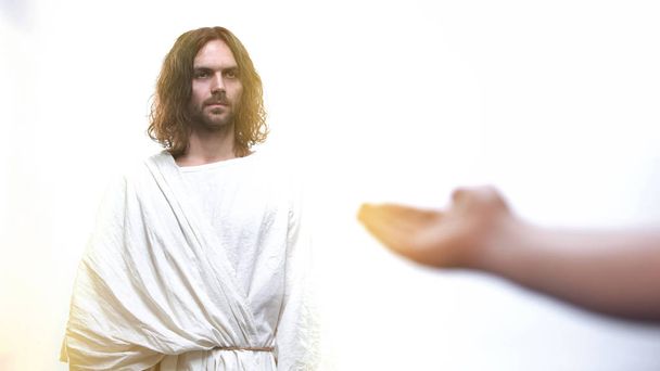 Male asking God for blessing and forgiveness, Jesus standing in holy light - Foto, Imagem