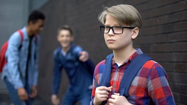 Evil teenagers laughing at new boy in school, calling names, verbal bullying - Zdjęcie, obraz