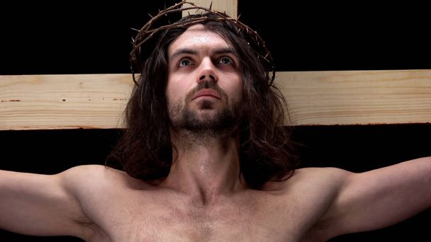 Crucified son of God looking up, religious self-sacrifice, bible history, belief - Valokuva, kuva