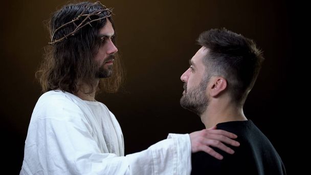 Christ and parishioner looking each other, help of spiritual power, support - Fotoğraf, Görsel