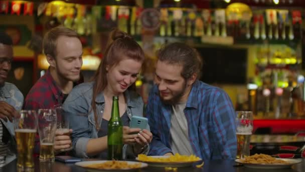 Fun Company Watches Photo On Phone In A Sport Bar. - Footage, Video