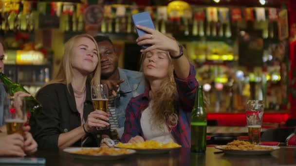 Fun Company Watches Photo On Phone In A Sport Bar. - Footage, Video