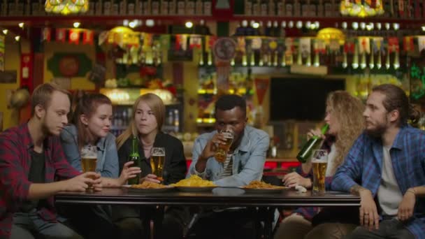 Přátelé popíjí pivo v pivovarském baru o víkendu-koncept přátelství s mladými lidmi, kteří si spolu užijí. Kamarádi pijí pivo v pivovaru. - Záběry, video