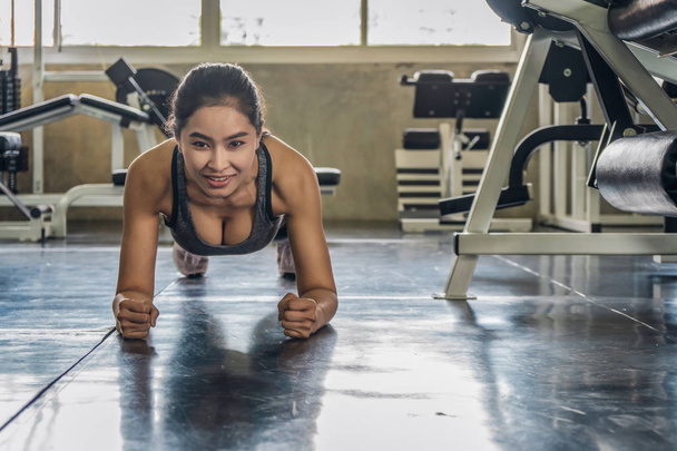 female exercising with push up in gym - Photo, image