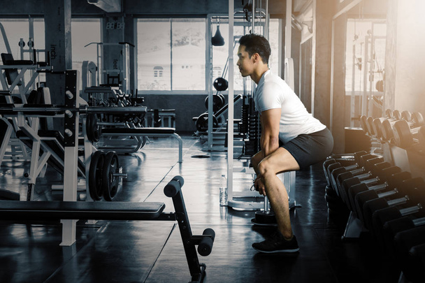 male lifting dumbbells in gym - Фото, изображение
