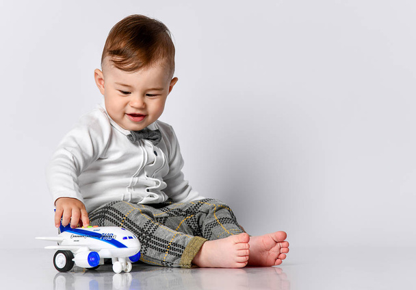 happy child toddler playing with toy airplane and dreaming of becoming a pilot - Foto, imagen