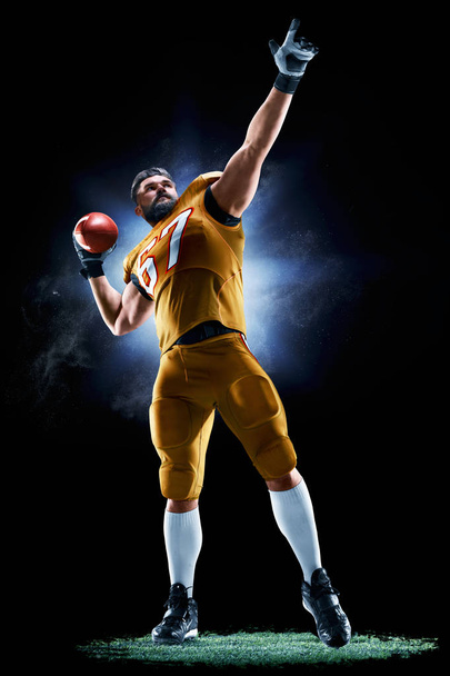 Proud american football player in the dark - Photo, Image