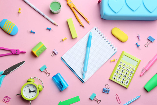 Bright school stationery on pink background, flat lay - Foto, afbeelding