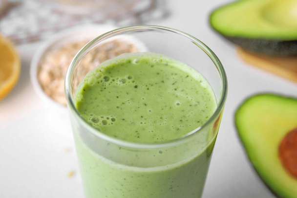 Glass of tasty avocado smoothie on table, closeup - Foto, immagini
