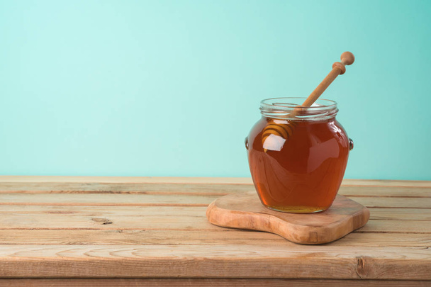 Jewish holiday Rosh Hashana background with honey jar on wooden  - Фото, изображение