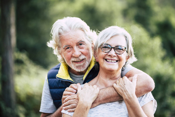 couple of cheerful happy senior people smiling and hugging in relationship - Photo, Image