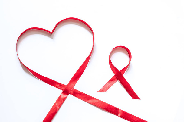 red ribbons on a white background symbol of love - heart and symbol of victory over the disease - Фото, зображення