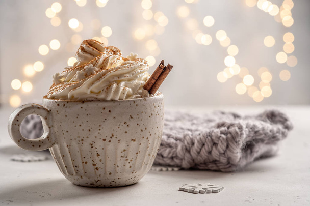 Hot chocolate with cream and cinnamon stick in a ceramic cup - Zdjęcie, obraz