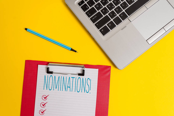 Writing note showing Nominations. Business photo showcasing action of nominating or state being nominated for prize Trendy metallic laptop clipboard paper sheet marker colored background. - Photo, Image