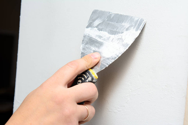 Worker with a trowel plastering a wall. Concept - Home Repair - Photo, Image