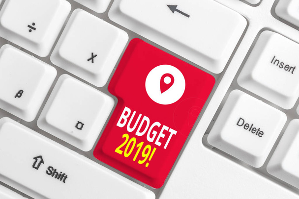 Writing note showing Budget 2019. Business photo showcasing estimate of income and expenditure for current year White pc keyboard with note paper above the white background. - Photo, Image