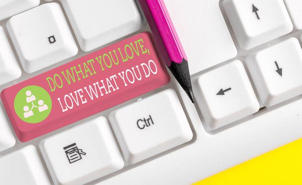 Text sign showing Do What You Love Love What You Do. Conceptual photo you able doing stuff you enjoy it to work in better places then White pc keyboard with empty note paper above white background key - Photo, Image