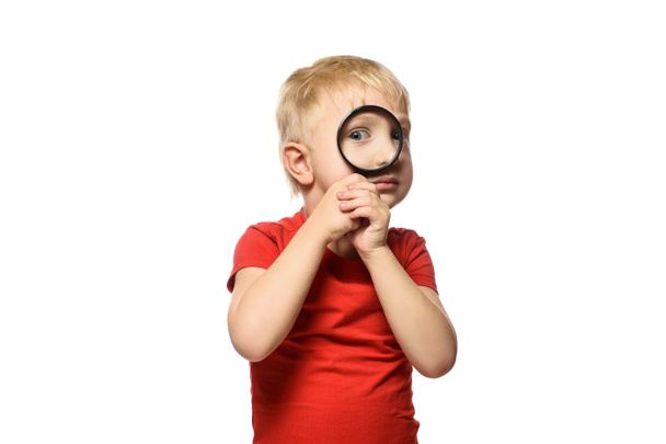 Blond boy with a magnifying glass in his hands. Little explorer. White background - Photo, Image