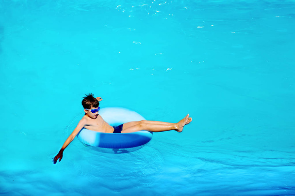 top view happy boy floats on rubber ring, carefree life concept - 写真・画像