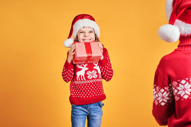 Happy children holding red gift boxes - Foto, Bild