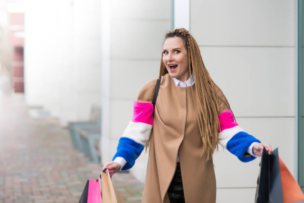 Mujer joven con muchas bolsas de colores después de grandes compras en la ma
 - Foto, Imagen