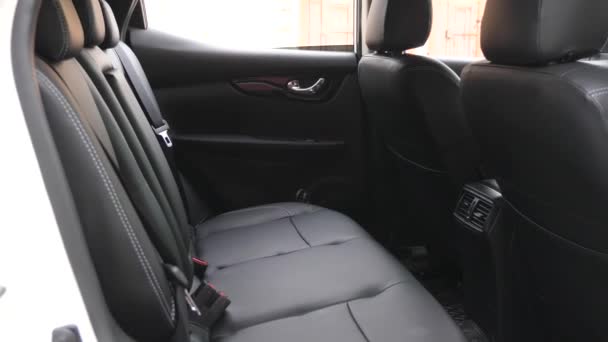 artificial leather rear seats in the car. Black leather seat covers in the car. beautiful leather car interior design. luxury leather seats in the car. - Footage, Video