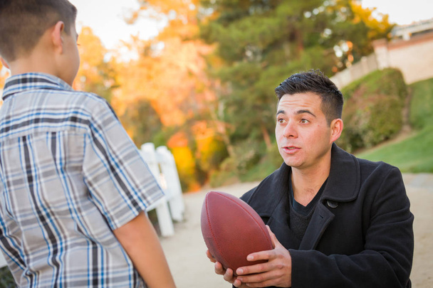 Hispanic Father Holding Football Teaching Young Boy - Fotoğraf, Görsel