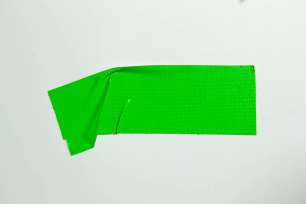 Set of green tapes on white background. Torn horizontal and different size green sticky tape, adhesive pieces. - Foto, afbeelding