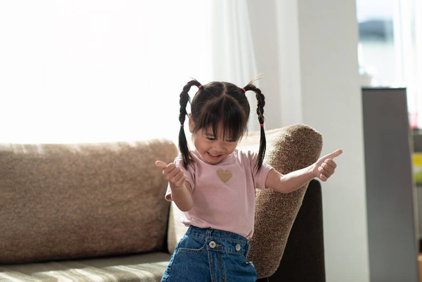 Happy Asian child having fun and dancing in a room - Fotoğraf, Görsel